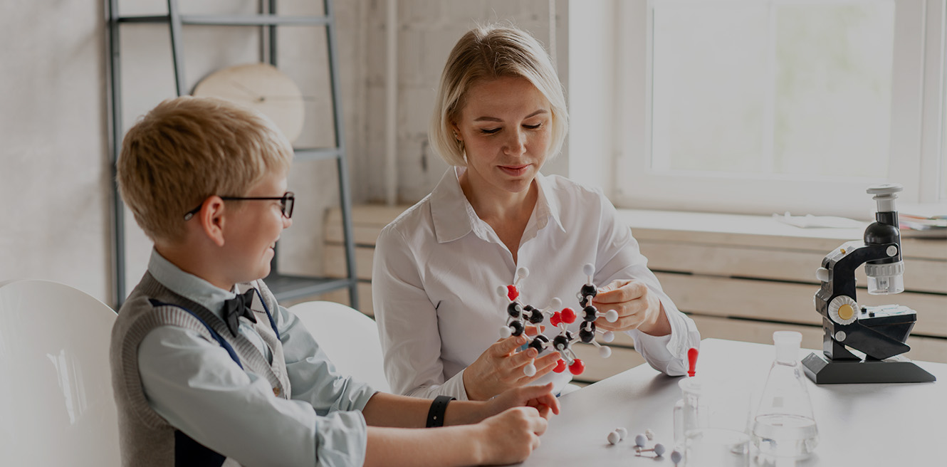 Female science tutor in Mesa studying chemistry with student